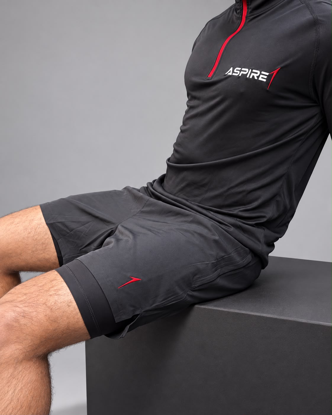 Aspire1 Training Shorts worn with the 1/4 Zip, seated